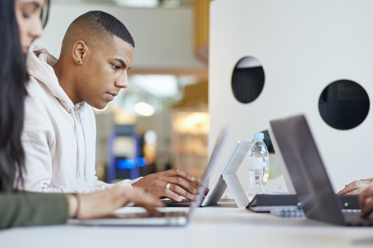 university students using laptops and digital tablet working together.jpg