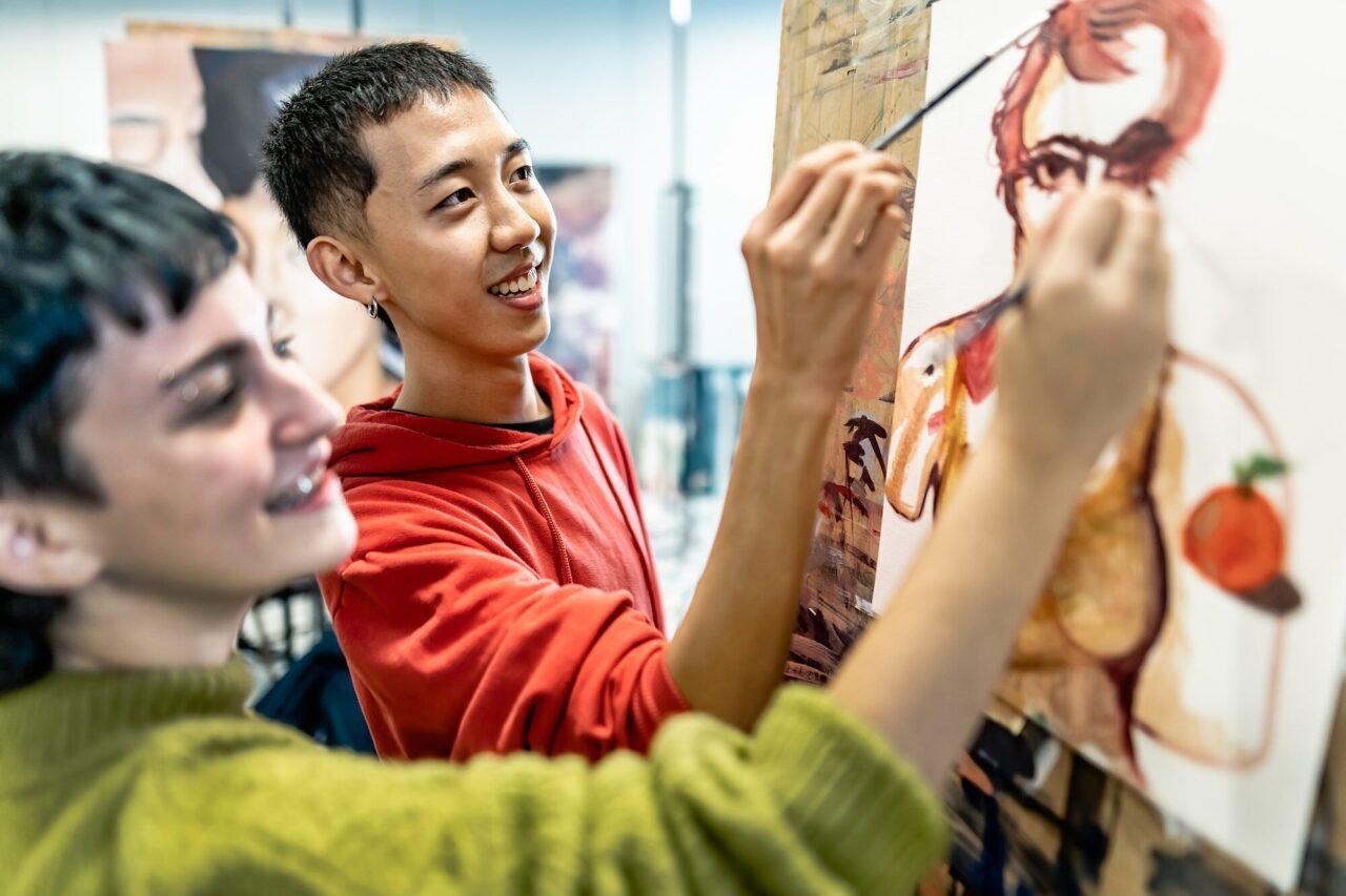 young students painting on canvas during lesson in faculty of arts university.jpg